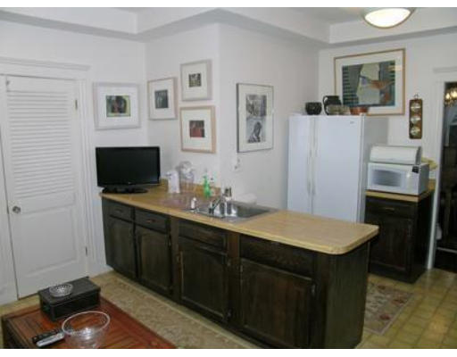 132 Sewall Avenue, Unit B Brookline, MA 02446 - Photo 8 of 18 a kitchen with a sink stove and refrigerator