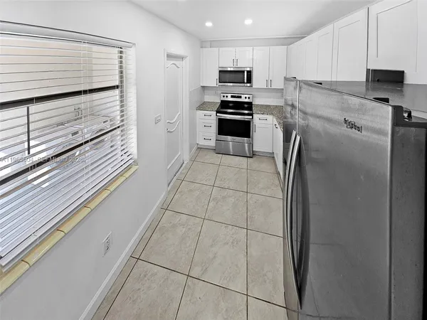 a kitchen with stainless steel appliances a refrigerator sink and stove