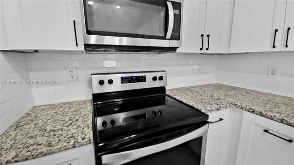 a kitchen with a stove and a microwave