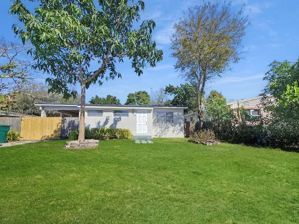 a backyard of a house with lots of green space and fountain