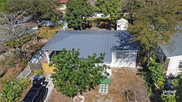 an aerial view of a house with a yard and garden