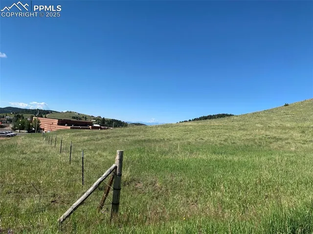a view of a field with an ocean view