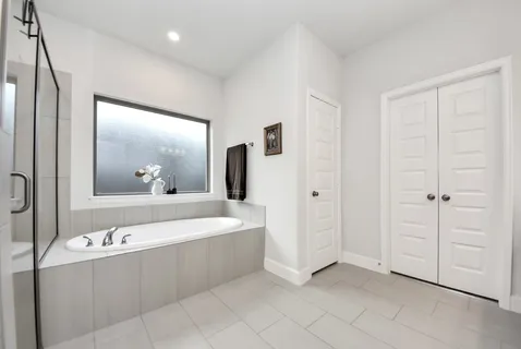 a view of bathroom with bathtub and mirror