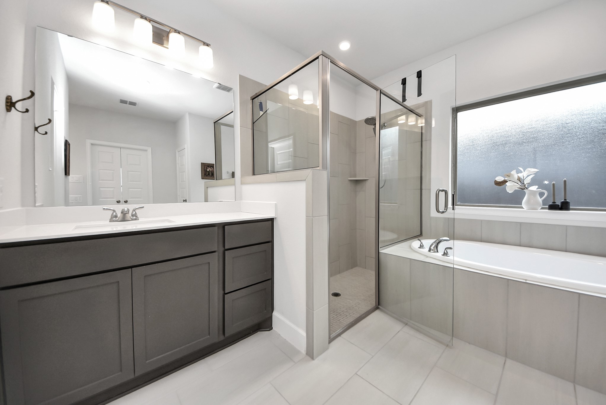 42546 Summer Crst Road Magnolia, TX 77354 - Photo 15 of 27 Owners bathroom features: Stone tiled flooring and throughout your separate shower, dual vanities with stone countertops and modern lighting.