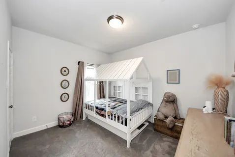 a bedroom with bed and a window