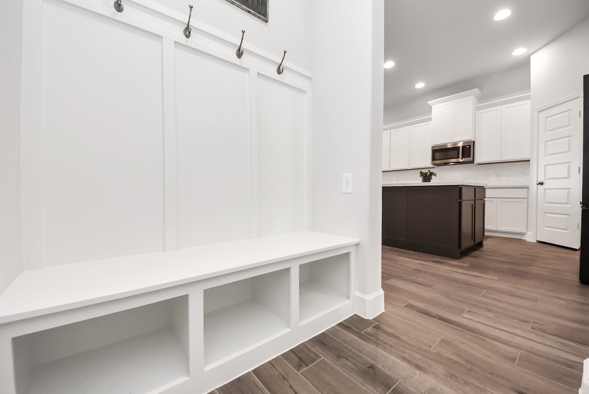 42546 Summer Crst Road Magnolia, TX 77354 - Photo 21 of 27 From your private garage, you step in your mud room area surrounded by wood tiled flooring providing a great functional space for traffic thru your garage.