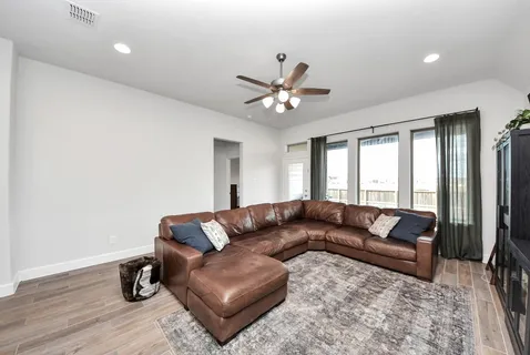 a living room with furniture and wooden floor