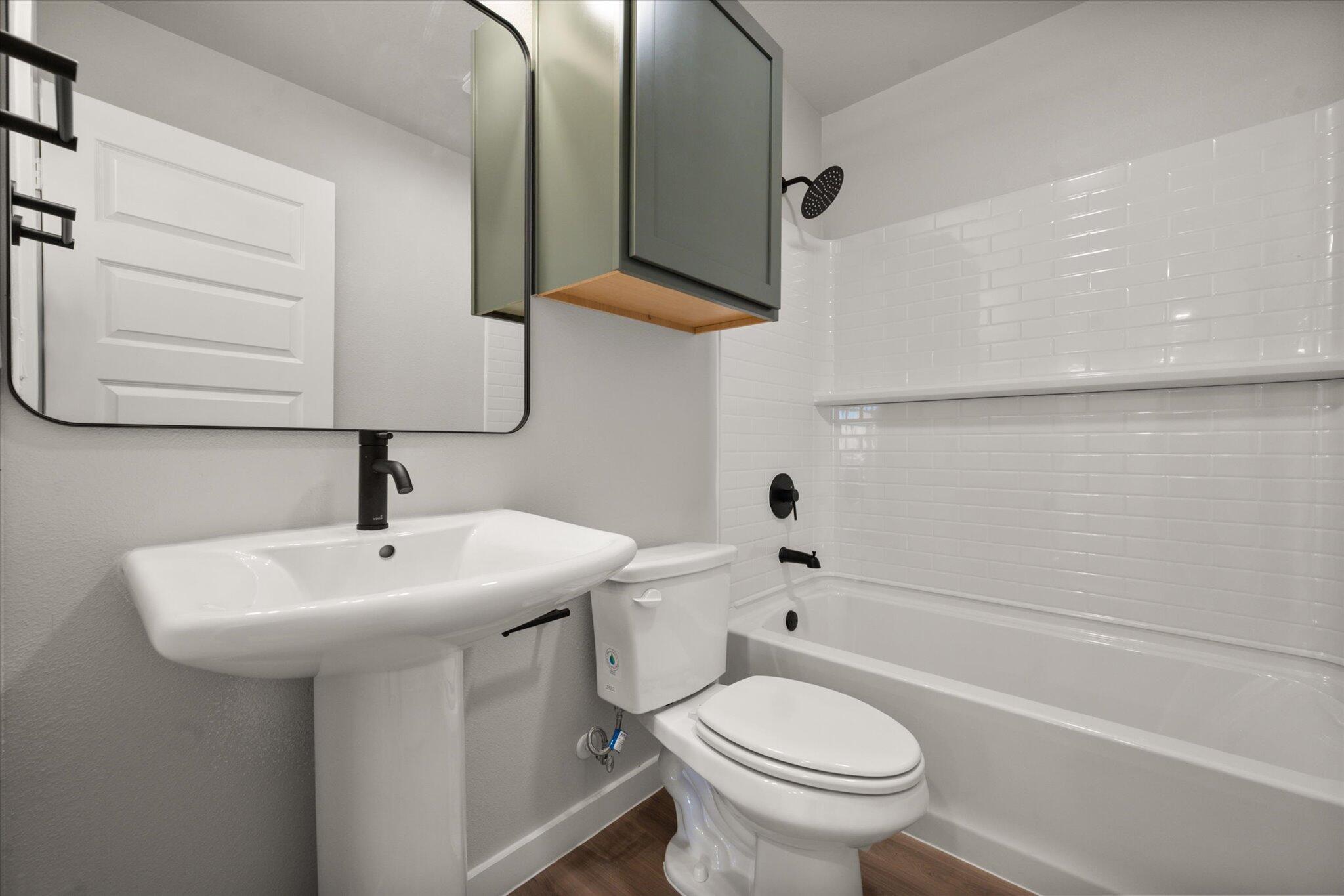 6302 Volney Avenue Lubbock, TX 79407 - Photo 18 of 20 a bathroom with a sink a toilet and shower