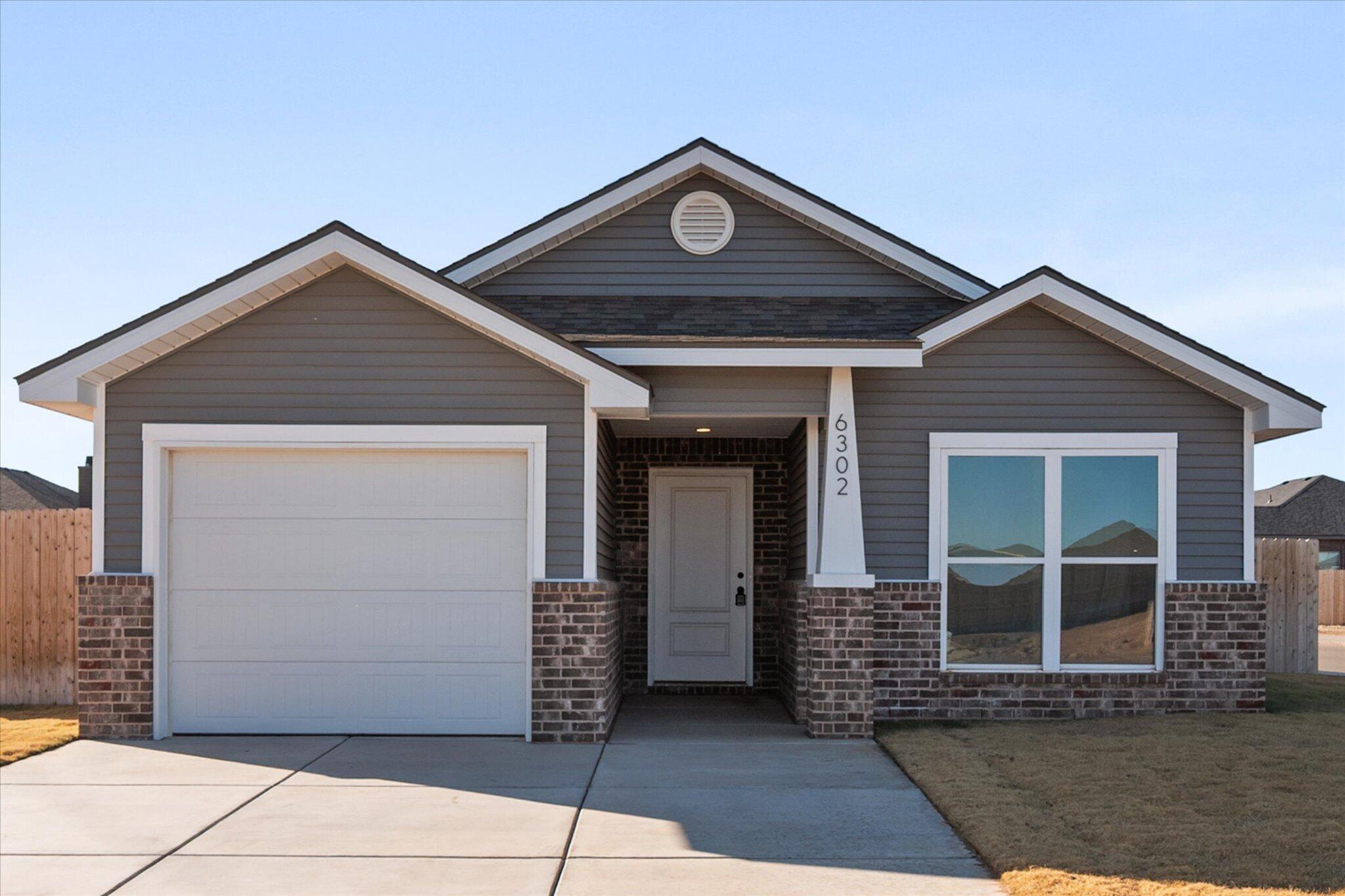 6302 Volney Avenue Lubbock, TX 79407 - Photo 2 of 20 a front view of a house with a garage