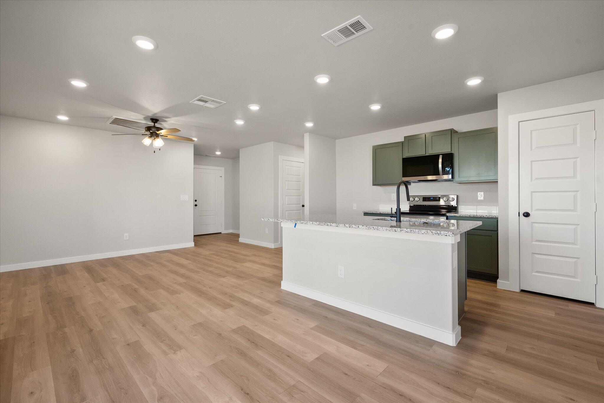6302 Volney Avenue Lubbock, TX 79407 - Photo 7 of 20 a view of kitchen with microwave refrigerator and cabinets