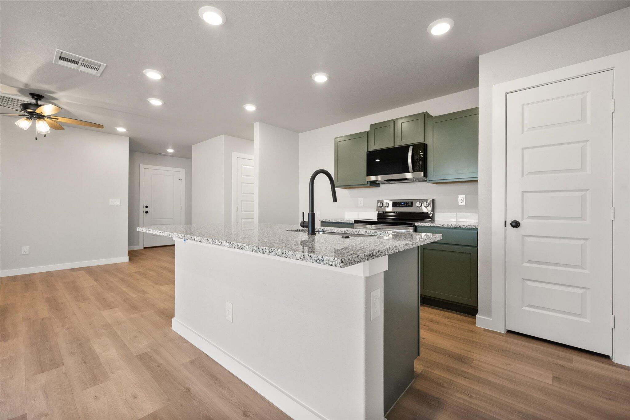 6302 Volney Avenue Lubbock, TX 79407 - Photo 9 of 20 a kitchen with kitchen island a sink stainless steel appliances and cabinets