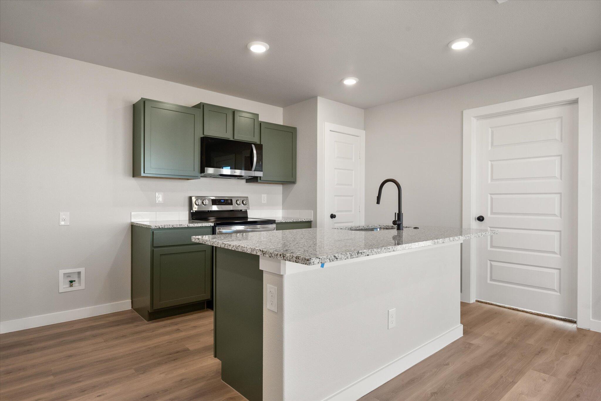 6302 Volney Avenue Lubbock, TX 79407 - Photo 10 of 20 a kitchen with a sink and a stove top oven