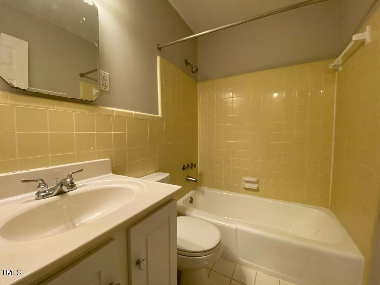 4706 Blue Bird Court, Unit I Raleigh, NC 27606 - Photo 13 of 16 a bathroom with a sink a toilet and shower