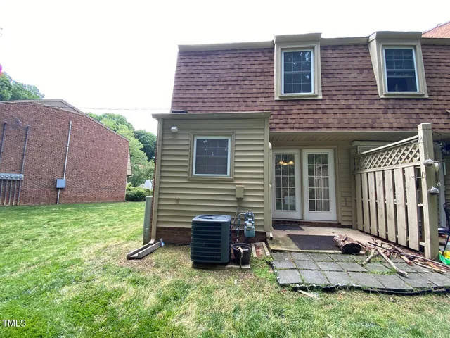 a view of a house with a yard and furniture