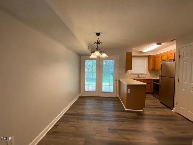 a view of a kitchen with a sink cabinet and a window