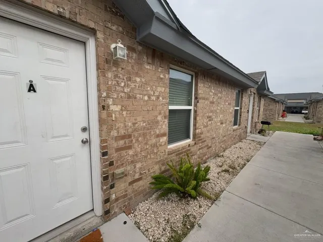 a backyard of a house with potted plants