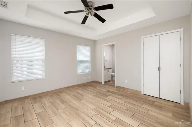 a bathroom with a granite countertop sink toilet and mirror