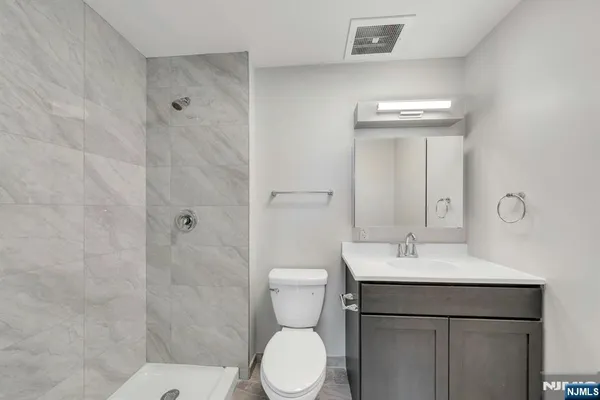 a bathroom with a toilet sink and shower