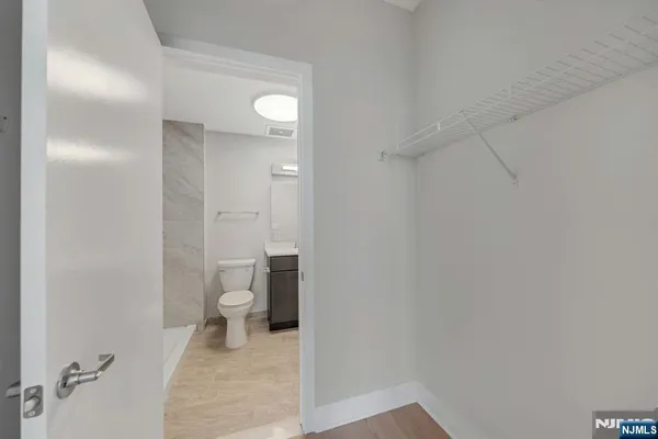 a bathroom with a granite countertop toilet and a shower