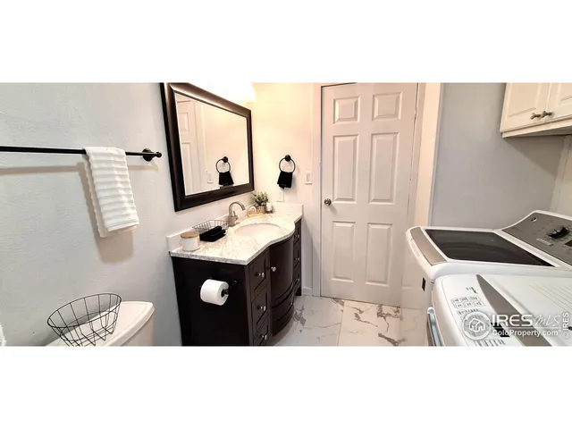 a bathroom with a sink vanity and mirror