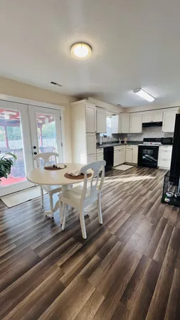 a view of kitchen and dining room with wooden floor