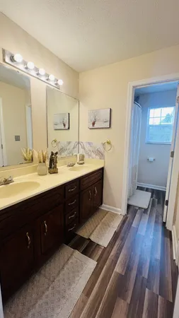 a bathroom with a double vanity sink and mirror