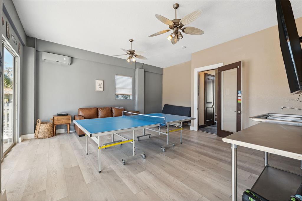 5287 Tuna Lane Weeki Wachee, FL 34607 - Photo 12 of 85 a living room with furniture a chandelier fan and a window
