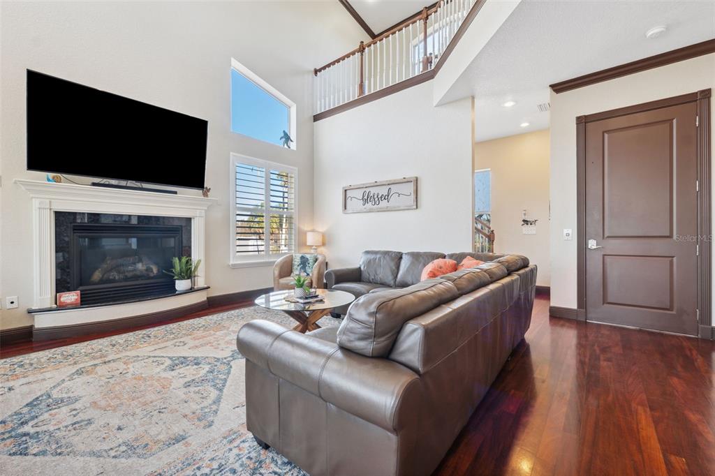 5287 Tuna Lane Weeki Wachee, FL 34607 - Photo 19 of 85 a living room with furniture a fireplace and a flat screen tv