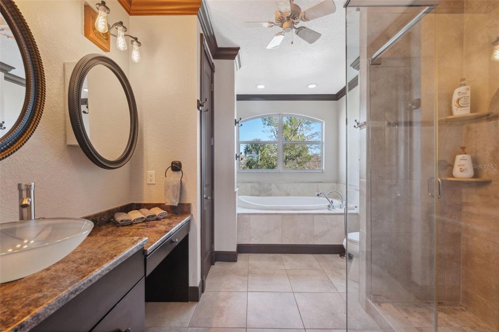 5287 Tuna Lane Weeki Wachee, FL 34607 - Photo 50 of 85 a bathroom with a granite countertop sink a mirror and a shower