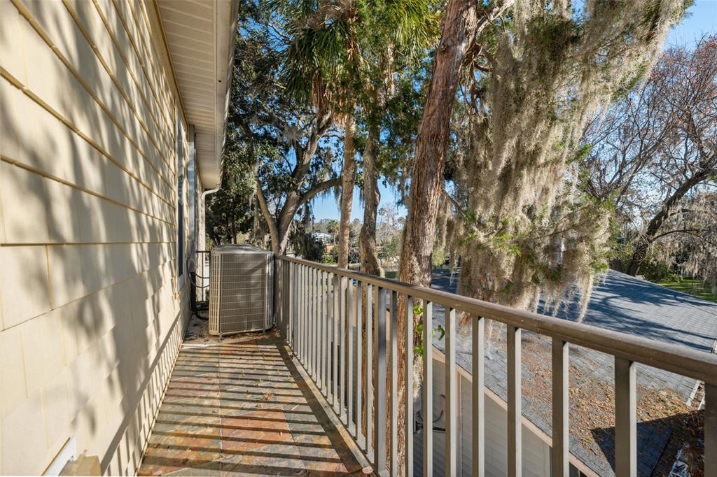 5287 Tuna Lane Weeki Wachee, FL 34607 - Photo 56 of 85 a view of a balcony with wooden floor and fence