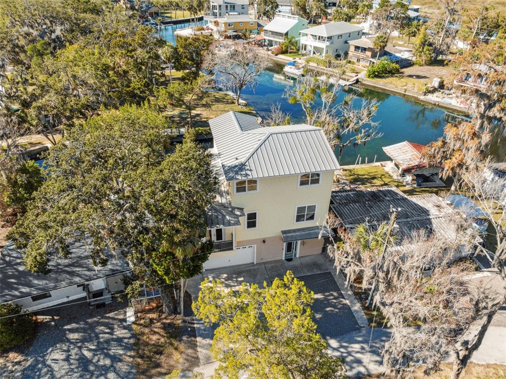 5287 Tuna Lane Weeki Wachee, FL 34607 - Photo 65 of 85 a aerial view of a house with a yard and lake view