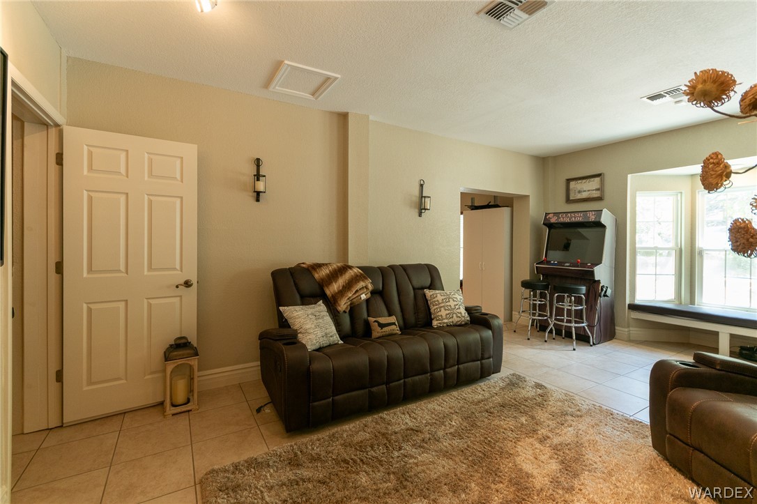 6615 Flag Mine Road Kingman, AZ 86401 - Photo 41 of 72 a living room with furniture and a flat screen tv