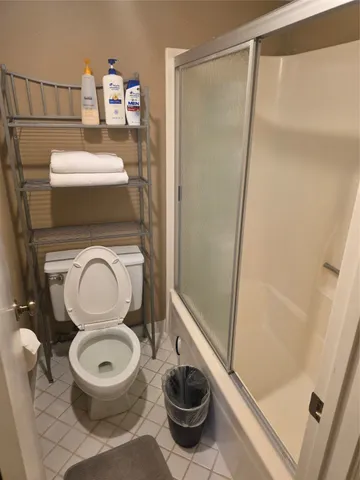 a bathroom with a toilet and a shower