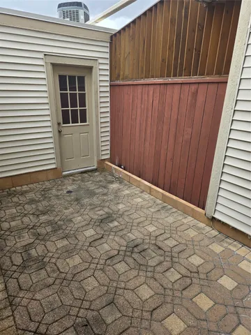 a view of backyard with wooden wall and window