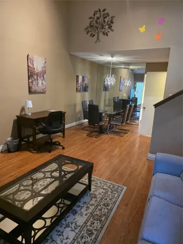 a living room with furniture a rug and a chandelier