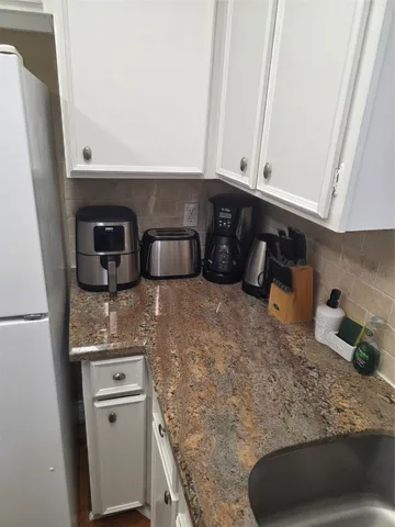 a kitchen with a sink and cabinets