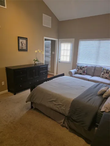 a bedroom with a bed and window