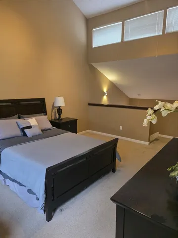 a bedroom with a bed and lamp