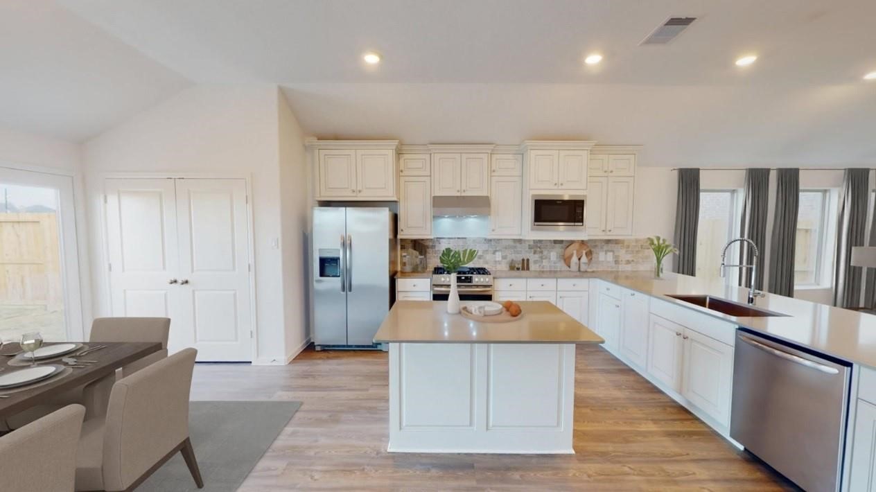2142 Mosaic Vly Court Angleton, TX 77515 - Photo 12 of 16 a large kitchen with cabinets and a counter top space