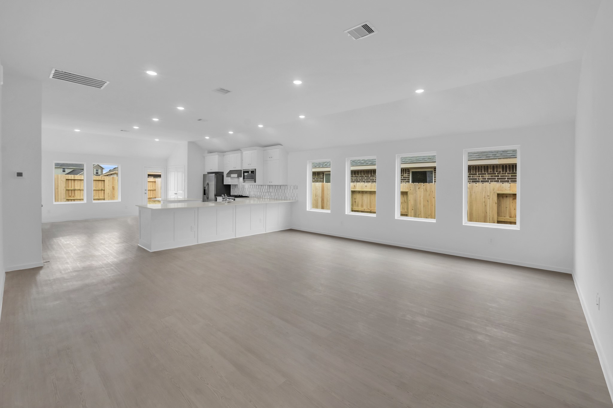 2142 Mosaic Vly Court Angleton, TX 77515 - Photo 6 of 16 a view of an empty room with a window and kitchen view