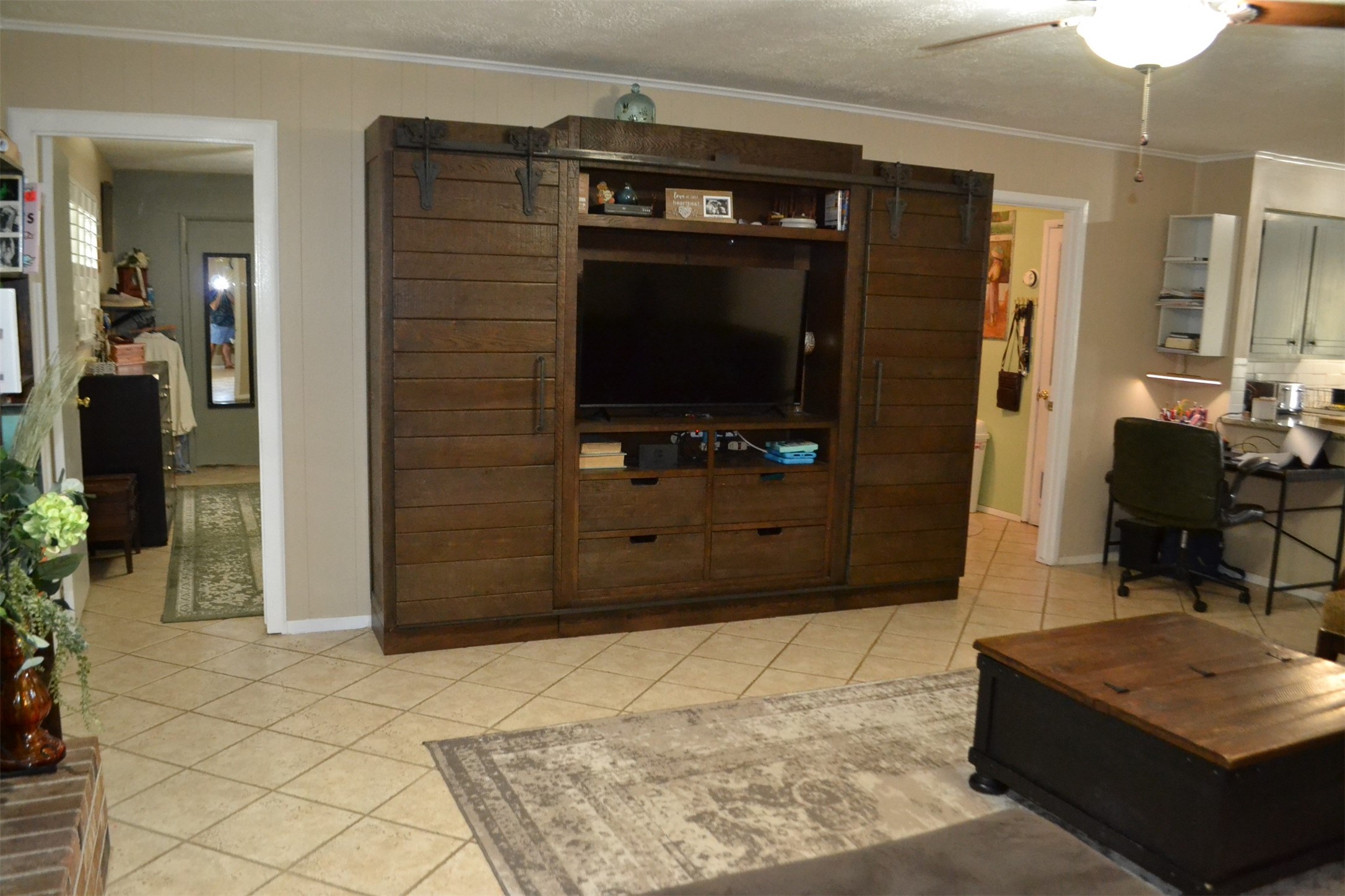 610 East X Street Deer Park, TX 77536 - Photo 22 of 44 a living room with a dresser and a flat screen tv