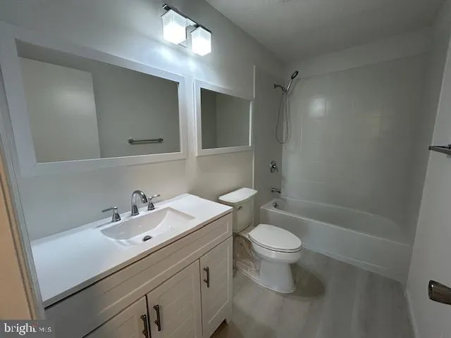 a bathroom with a sink toilet mirror and shower