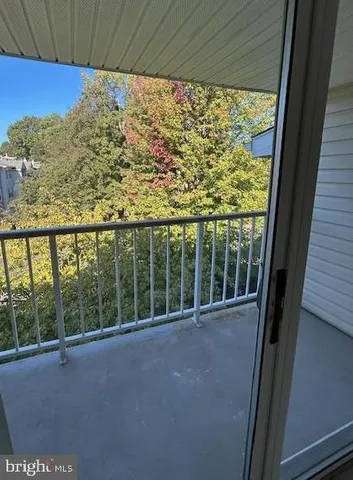 a picture of a bench in front of a wall