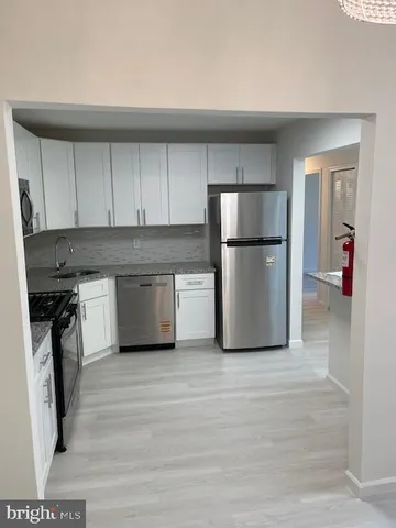 a kitchen with a refrigerator and a stove