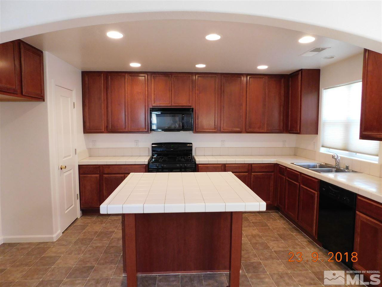 1606 Lone Oak Trail Reno, NV 89523 - Photo 3 of 10 a kitchen with a sink and a stove top oven