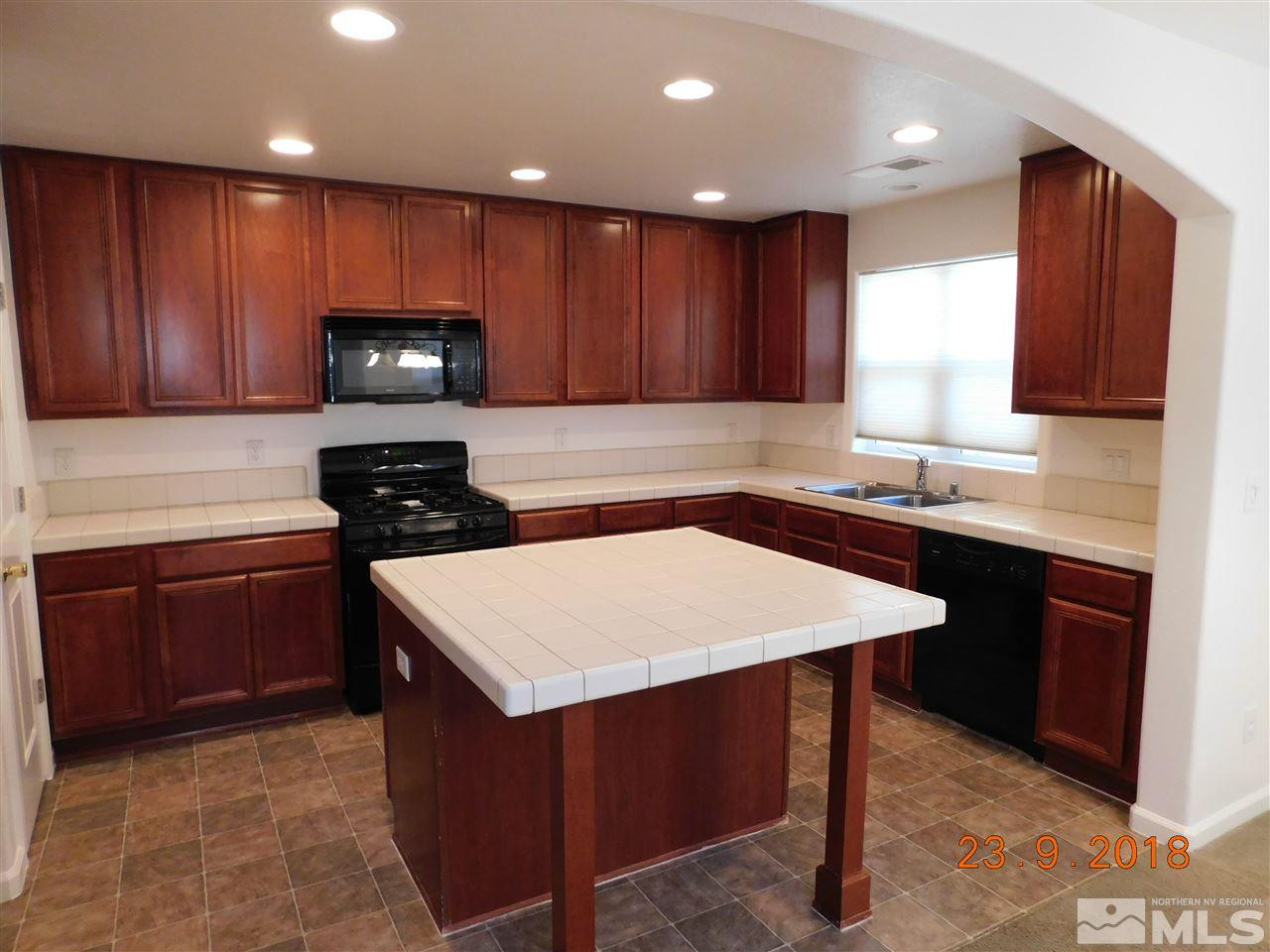 1606 Lone Oak Trail Reno, NV 89523 - Photo 4 of 10 a kitchen with a sink a stove cabinets and wooden floor