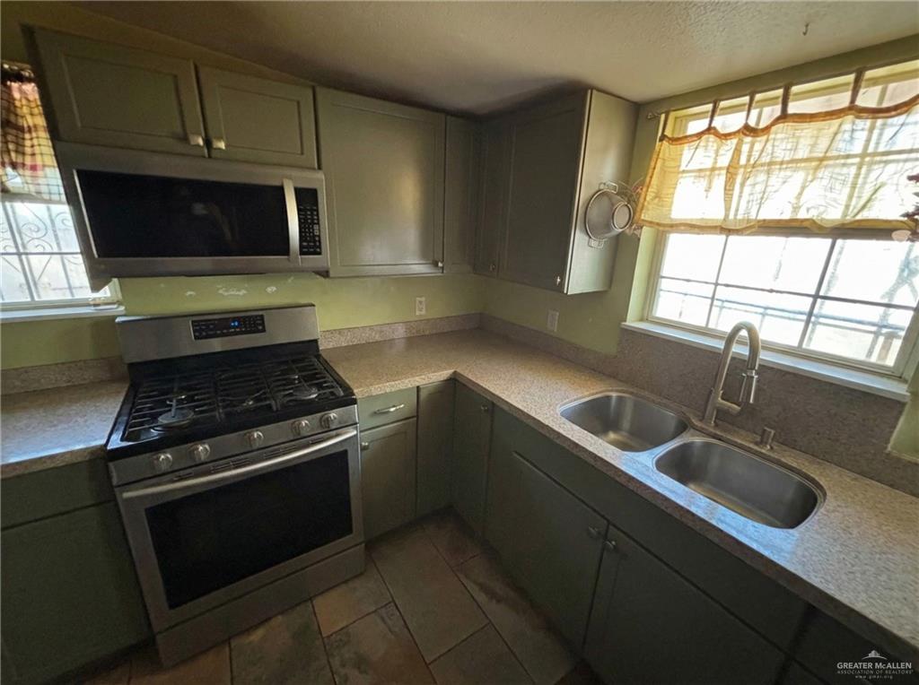 1901 South 34th Street McAllen, TX 78503 - Photo 3 of 13 a kitchen with a stove and a sink