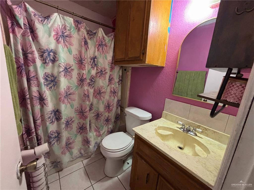 1901 South 34th Street McAllen, TX 78503 - Photo 10 of 13 a bathroom with a toilet sink and mirror