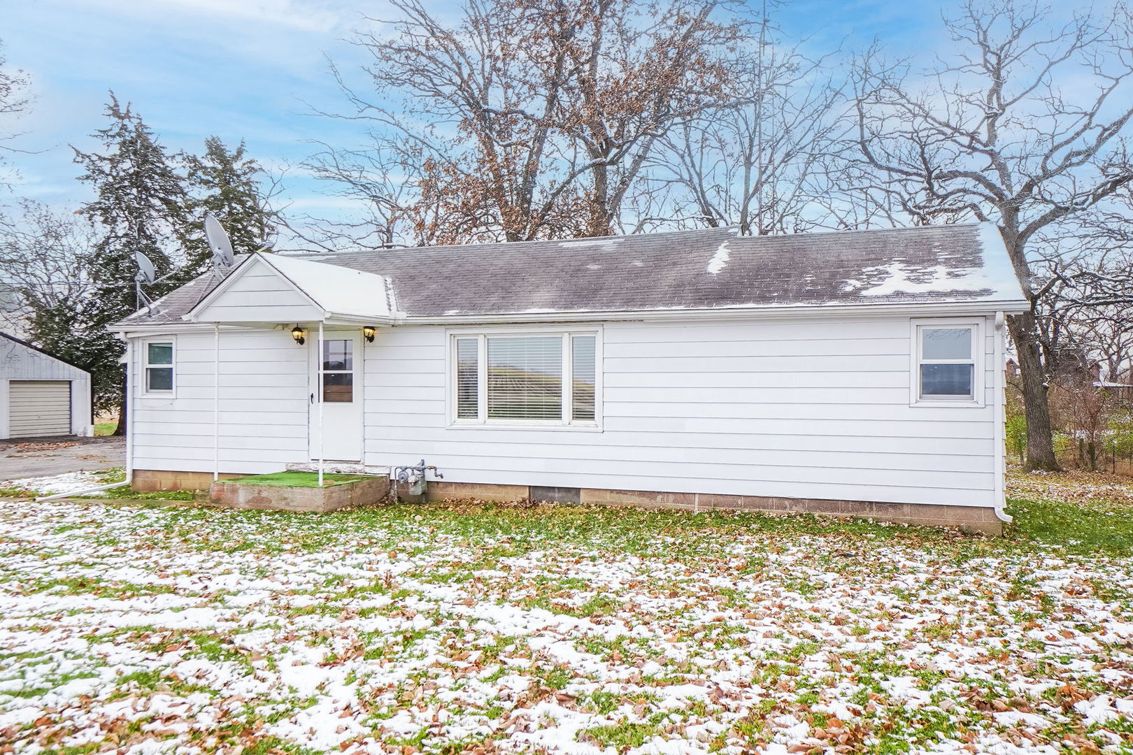 1737 Lee Center Road Amboy, IL 61310 - Photo 2 of 19 a house with trees in the background