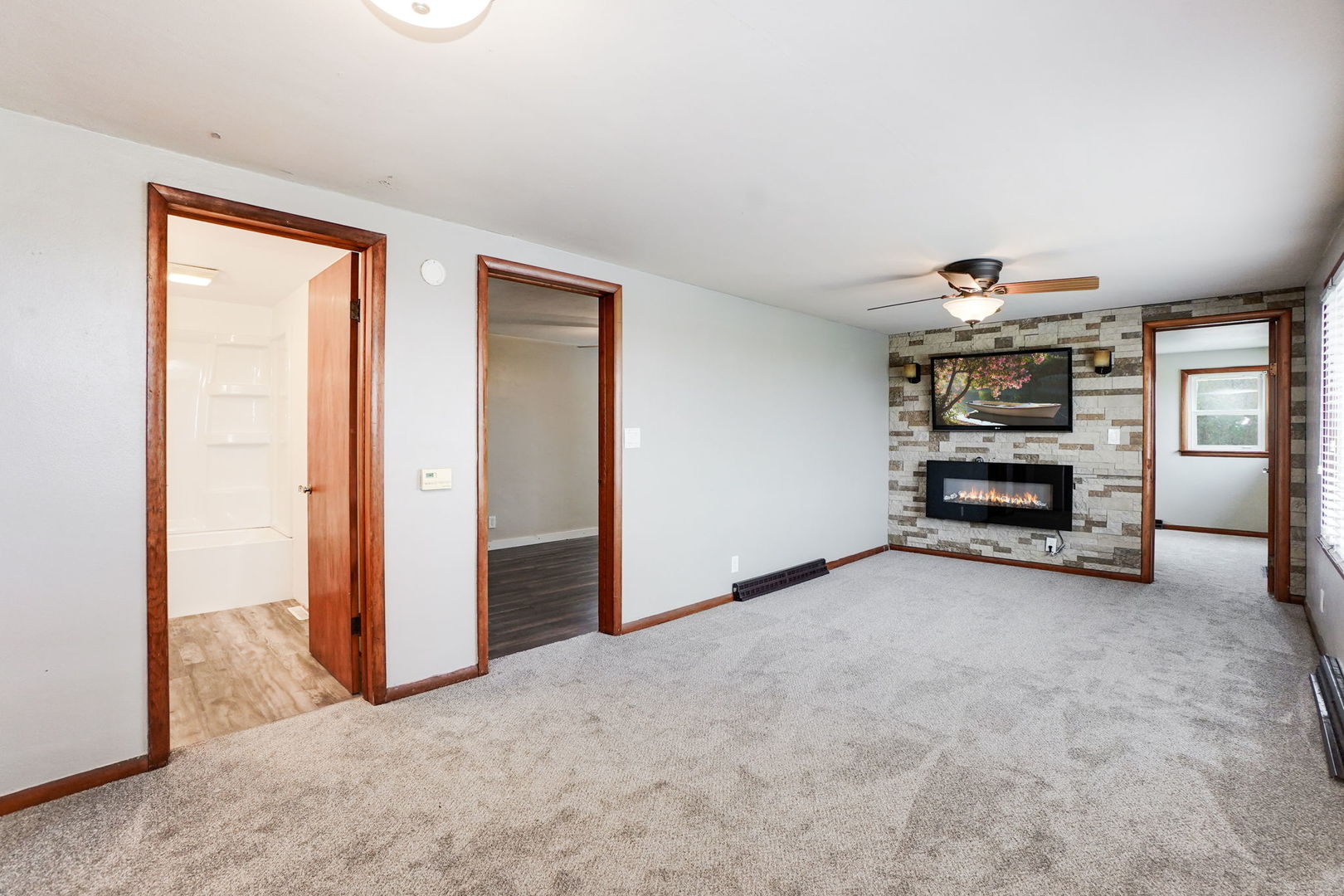 1737 Lee Center Road Amboy, IL 61310 - Photo 4 of 19 an empty room with a door and a rug